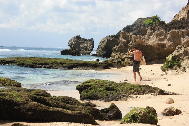 a man searches for the other half of his surfboard