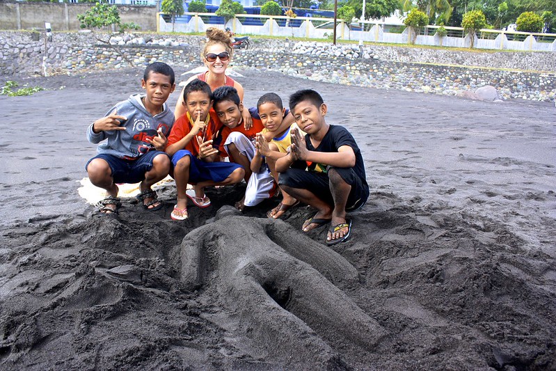 Lina and a bunch of local kids with their sand statue of me Lina and a bunch of local kids with their sand statue of me