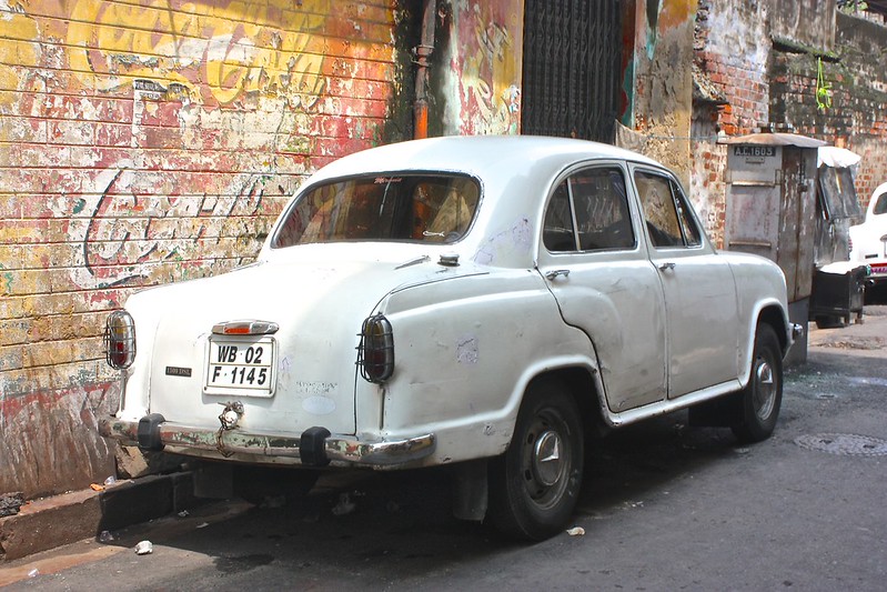 Kolkata car in front of a vintage Coca-Cola ad Kolkata car in front of a vintage Coca-Cola ad