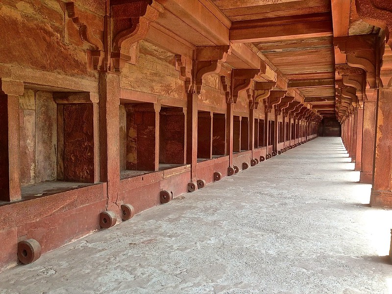 "This large colonnaded enclosure, wrongly called camel stables, elephant stables and horse stables, was probably intended for housing the servicing maids of the ladies palaces. For which an entrance was provided in the north. For the sanitary needs of the