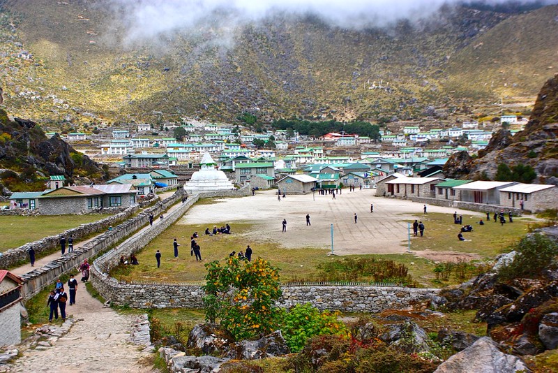 Soccer field at The Hillary School in Khumjung flanked by tablets of Buddhist mantras
