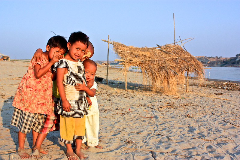 kids living in a fishing village on a sand bar in the river