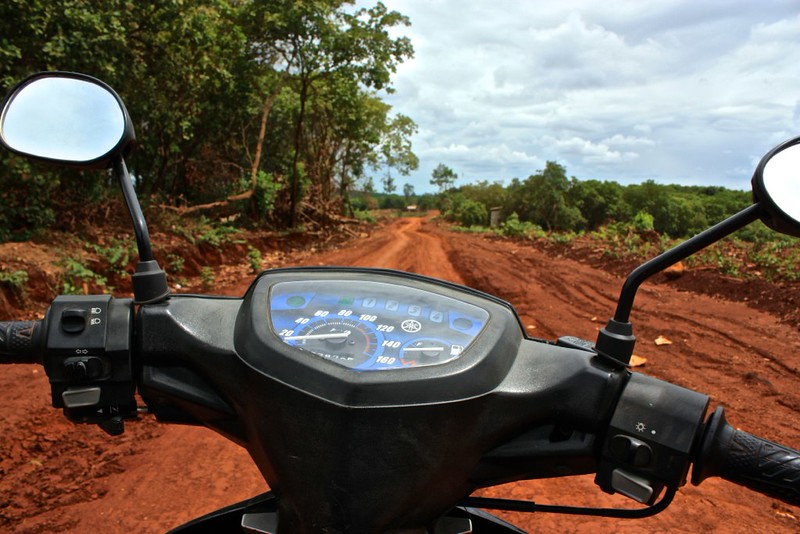 a motorbike's perspective: a windy mud road a motorbike's perspective: a windy mud road