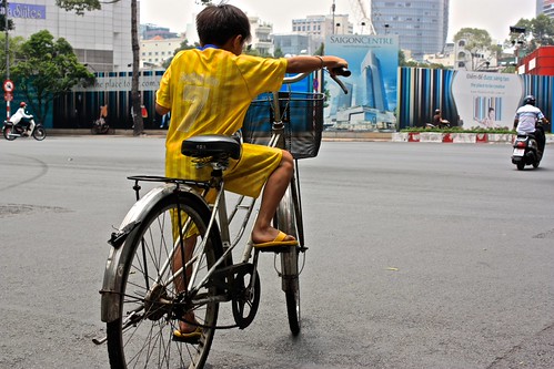 a determined kid on an oversized bike