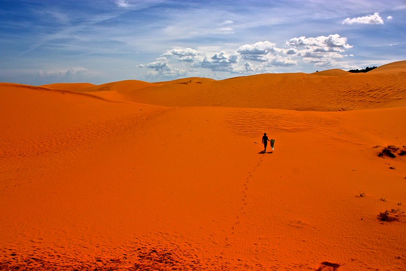 Me walking across the red sand dunes with my sled Me walking across the red sand dunes with my sled