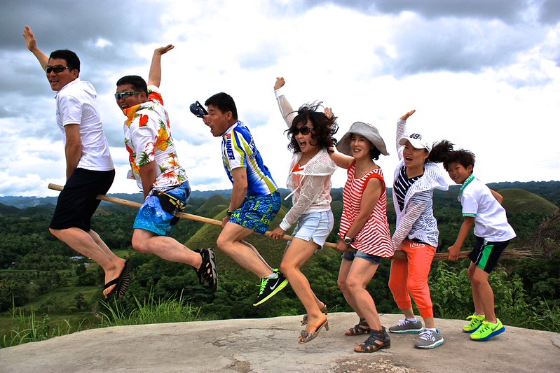 Asian tourists try their hand at a jumping shot Asian tourists try their hand at a jumping shot